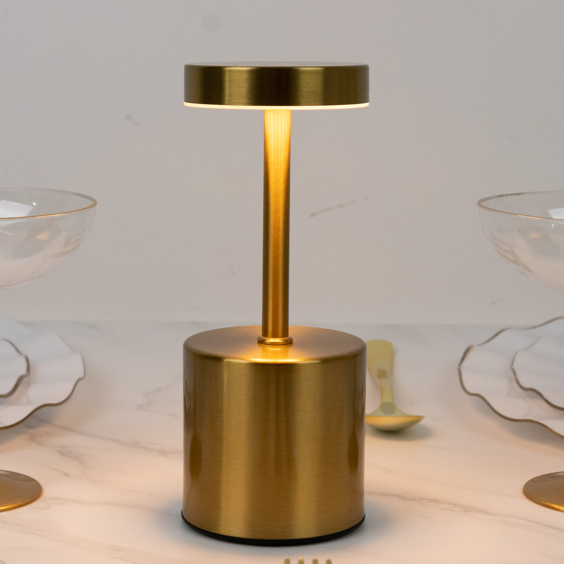 Gold modern table lamp with a sleek design and warm glow.