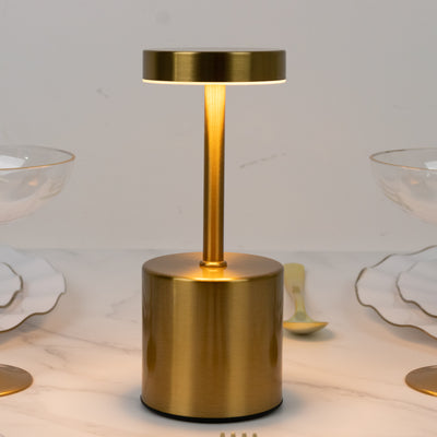 Gold modern table lamp with a sleek design and warm glow.