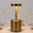 Gold modern table lamp with a sleek design and warm glow.