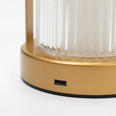 Gold lamp base with USB-C charging port on a white background.