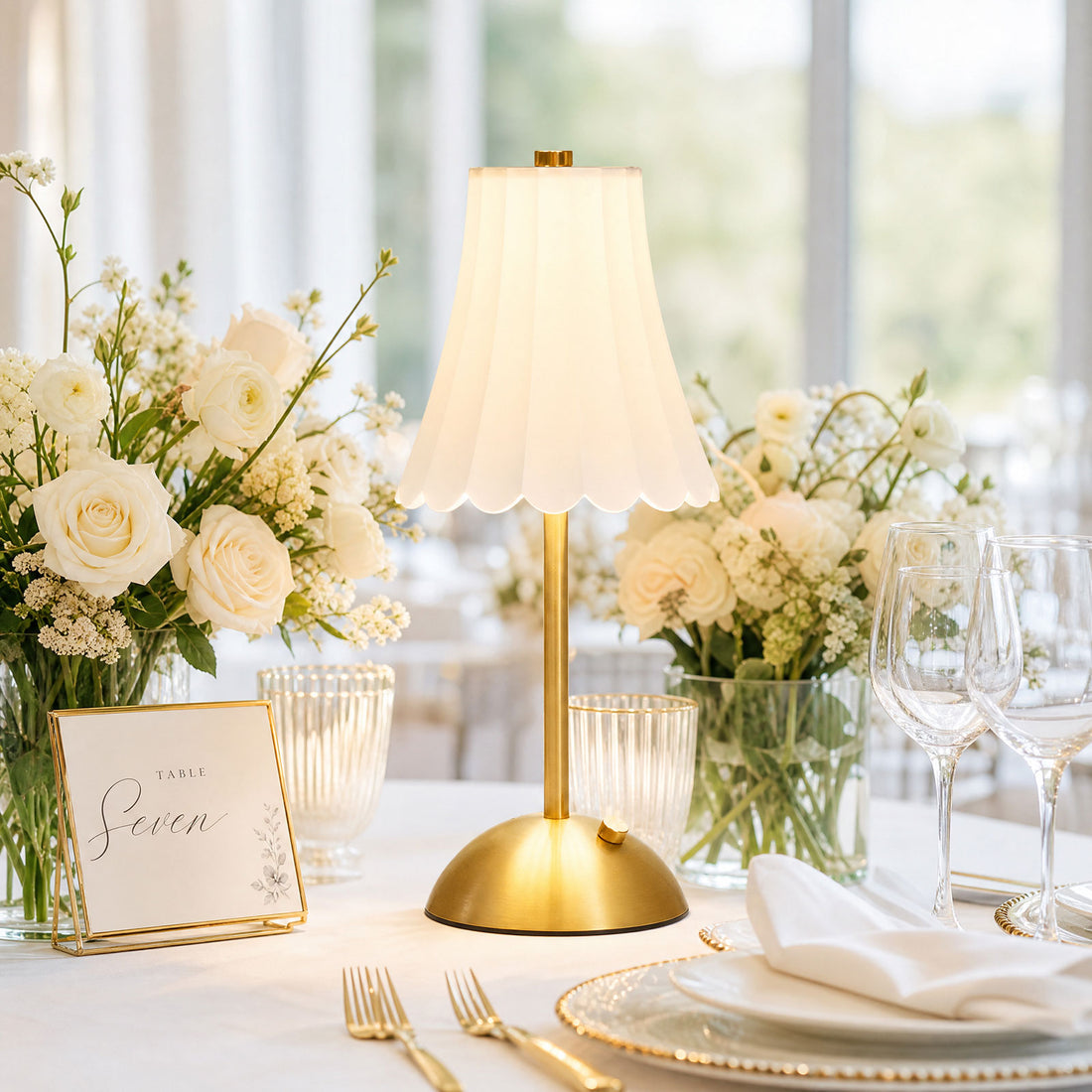 Elegant wedding table centerpiece with gold lamp and white roses