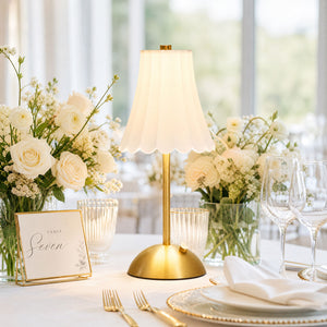 Elegant wedding table centerpiece with gold lamp and white roses