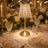 Elegant gold and crystal wedding table centerpiece with candles and white roses