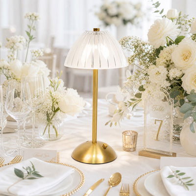 Elegant gold table lamp centerpiece on a white floral wedding table setting