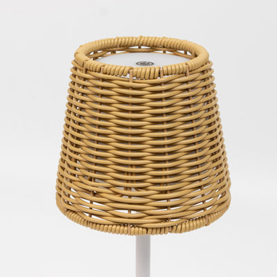 Wicker rattan stool with white base on a plain background