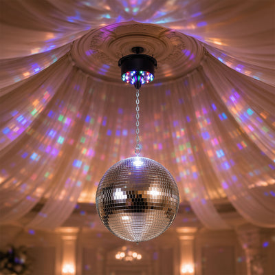 Disco ball with colorful light reflections on ornate ceiling