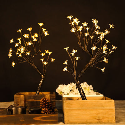 LED flower branches in wooden boxes, creating a warm ambiance.
