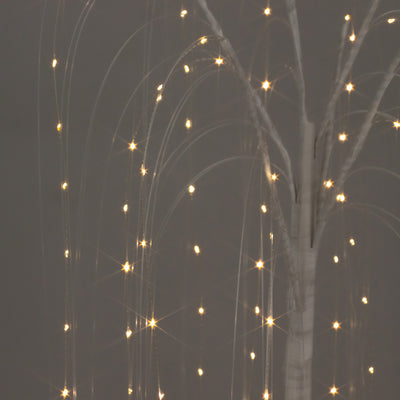Illuminated decorative tree with twinkling lights against a dark backdrop.