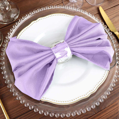 Purple bow napkin on a decorative plate setting.