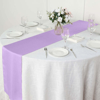 Purple table runner on a round table set for dining.