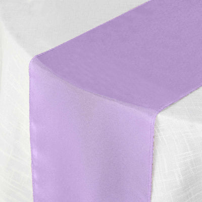 Purple satin table runner on a white tablecloth.