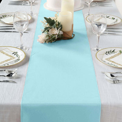 Elegant turquoise table runner on a styled dining table with floral accents.