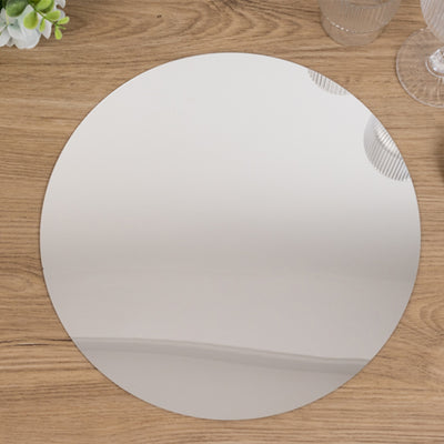 Round mirror tabletop on wooden surface.