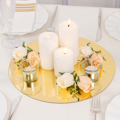 Elegant candle arrangement with roses on a gold mirror tray.