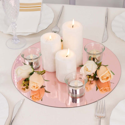 Elegant candle centerpiece with pink mirror base and fresh roses.