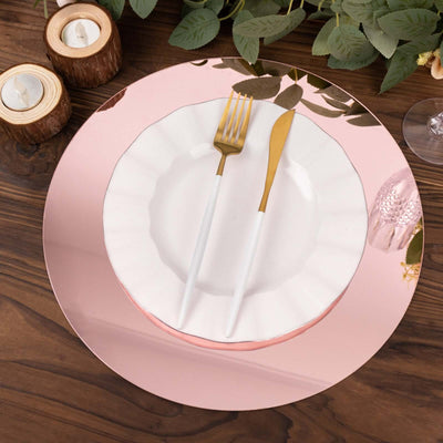 Elegant white plate with gold utensils on a mirrored charger.