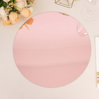 Round pink mirror on a white background.