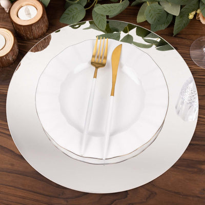 Elegant dining set with gold utensils on a reflective plate.