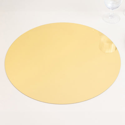 Gold round mirror tray on a plain surface.