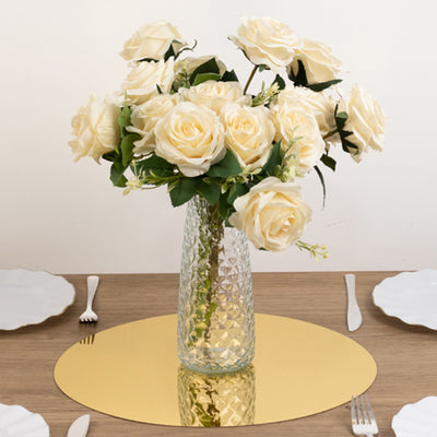 Elegant white rose bouquet in a glass vase on a table setting.