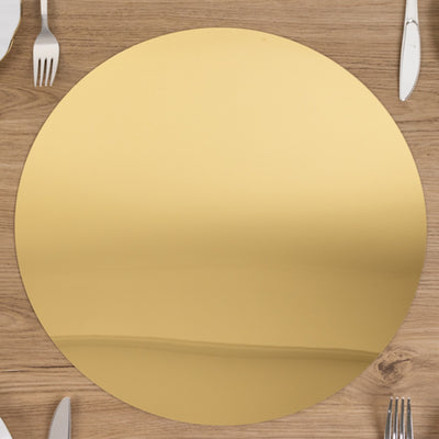 Gold round placemat on a wooden table setting.