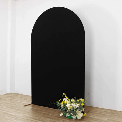 Black arch backdrop with floral arrangement at the base.