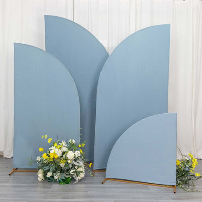Blue fabric backdrops with floral arrangement in front.