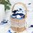 Hessian basket filled with blue and white flower petals.