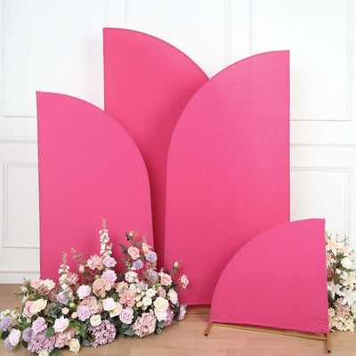 Pink curved backdrop panels with flowers in a studio setting.
