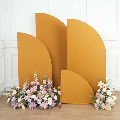Decorative mustard yellow backdrop with floral arrangement in front.