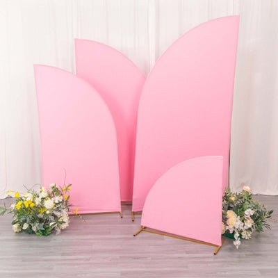 Pink decorative backdrops with floral arrangements in a studio setting.