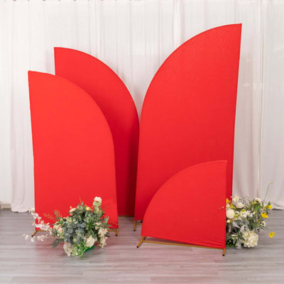 Red decorative panels with floral arrangements in front of a white backdrop.