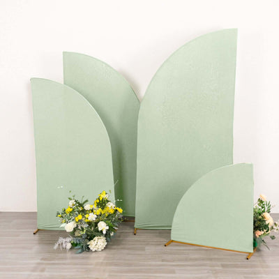 Green decorative backdrops with floral arrangement in front.