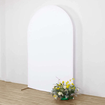 White arch backdrop with fresh flowers in a green pot.