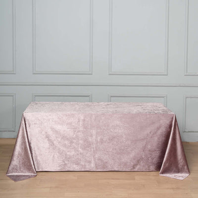 Pink velvet tablecloth draped elegantly on a wooden table.