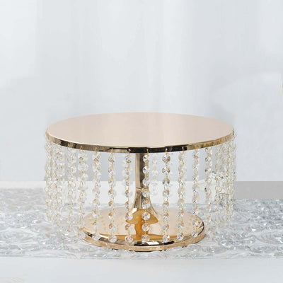 Gold accent table with crystal beaded fringe on a white background.