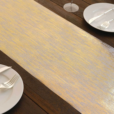 Elegant gold and silver table runner on a rustic wooden table setting.