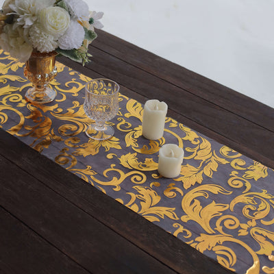 Elegant gold and silver table runner with ornate design on a wooden table.