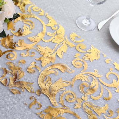 Elegant gold floral table runner on a textured gray tablecloth.
