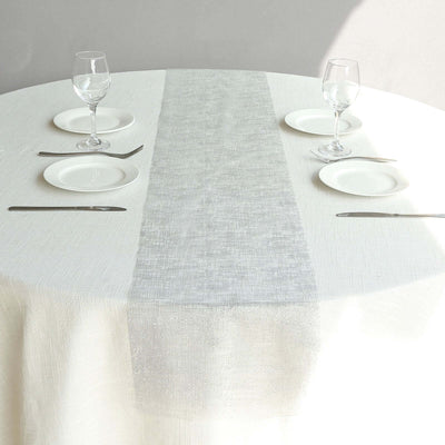 Elegant table setting with a minimalist design, featuring glasses and plates.