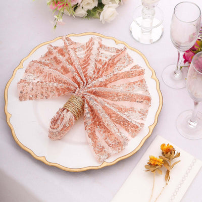 Elegant rose gold sequin napkin on a decorative plate with floral accents.