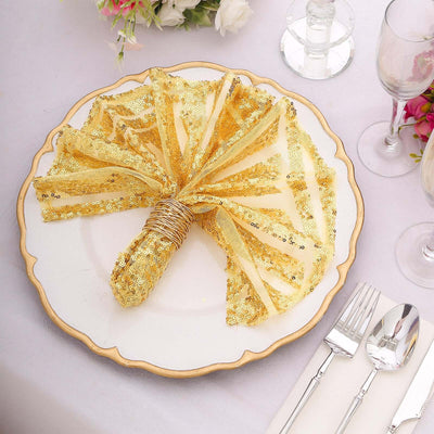 Gold sequin napkin elegantly arranged on a decorative plate at a table setting.