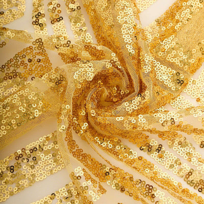 Gold sequin fabric with intricate patterns and textures.