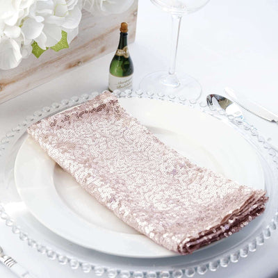 Rose gold sequin napkin elegantly arranged on a white dinner plate.