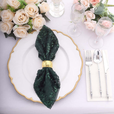 Elegant green napkin on a decorative plate with flowers and cutlery.