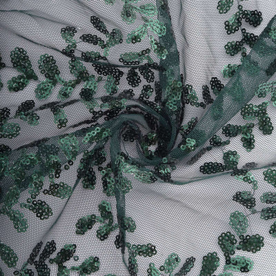 Green sequined lace fabric with floral patterns and intricate details.