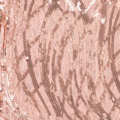 Rose gold sequin fabric with intricate patterns and shimmering texture.