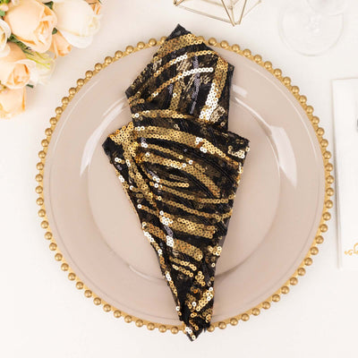 Gold and black sequin napkin elegantly displayed on a decorative plate.