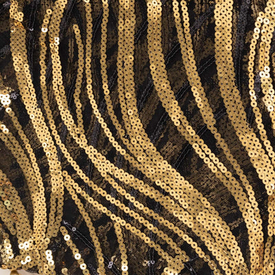 Black and gold sequined fabric with wavy patterns.