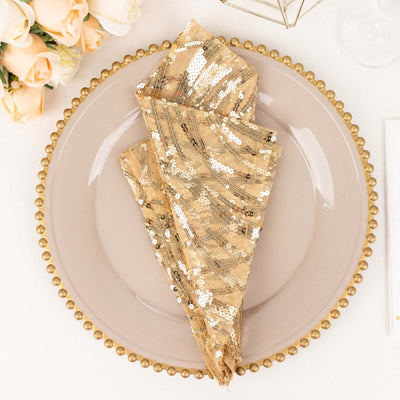 Gold sequin napkin elegantly folded on a decorative plate.